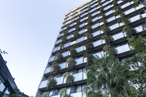 Enjoy stunning views from the spacious balconies, each adorned with lush greenery.