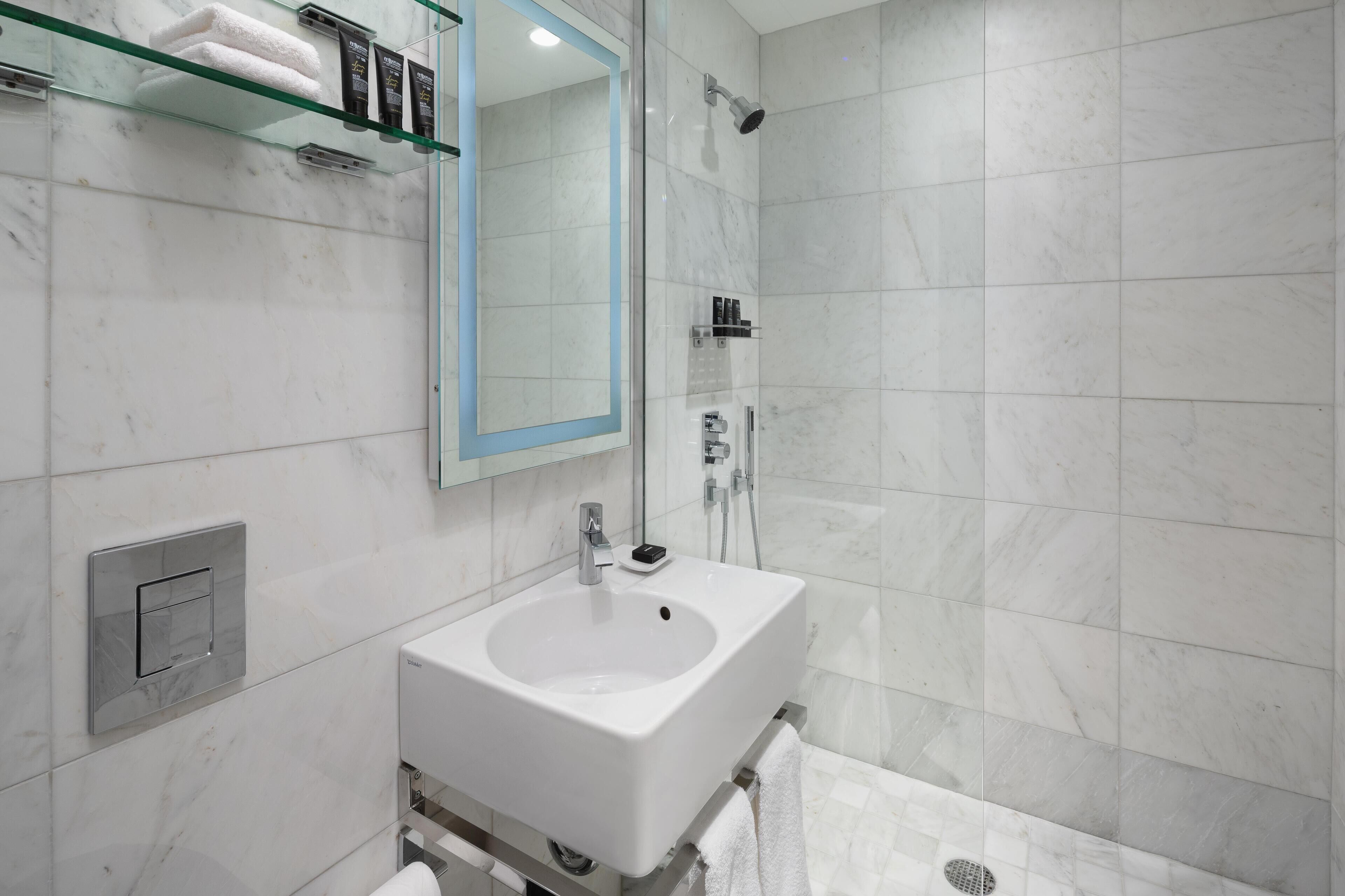 Shower, designer toiletries, hair dryer, bathrobes