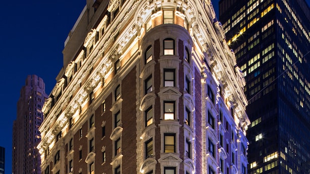 A historic building with ornate architectural details, multiple floors, and a prominent corner design.