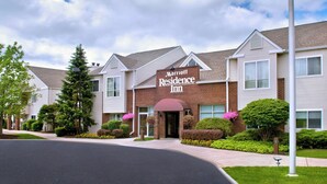 A Marriott Residence Inn with a brick facade, multiple windows, and a well-maintained lawn. - Residence Inn Syracuse Carrier Circle (East Syracuse)