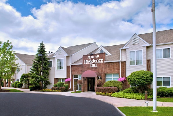 Ein Marriott Residence Inn mit Backsteinfassade, zahlreichen Fenstern und einem gepflegten Rasen.