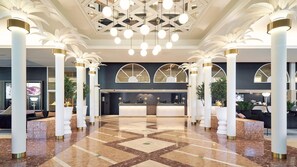 A spacious lobby with a reception desk, white columns, and a geometric ceiling design. - Naantali Spa Hotel (Naantali)