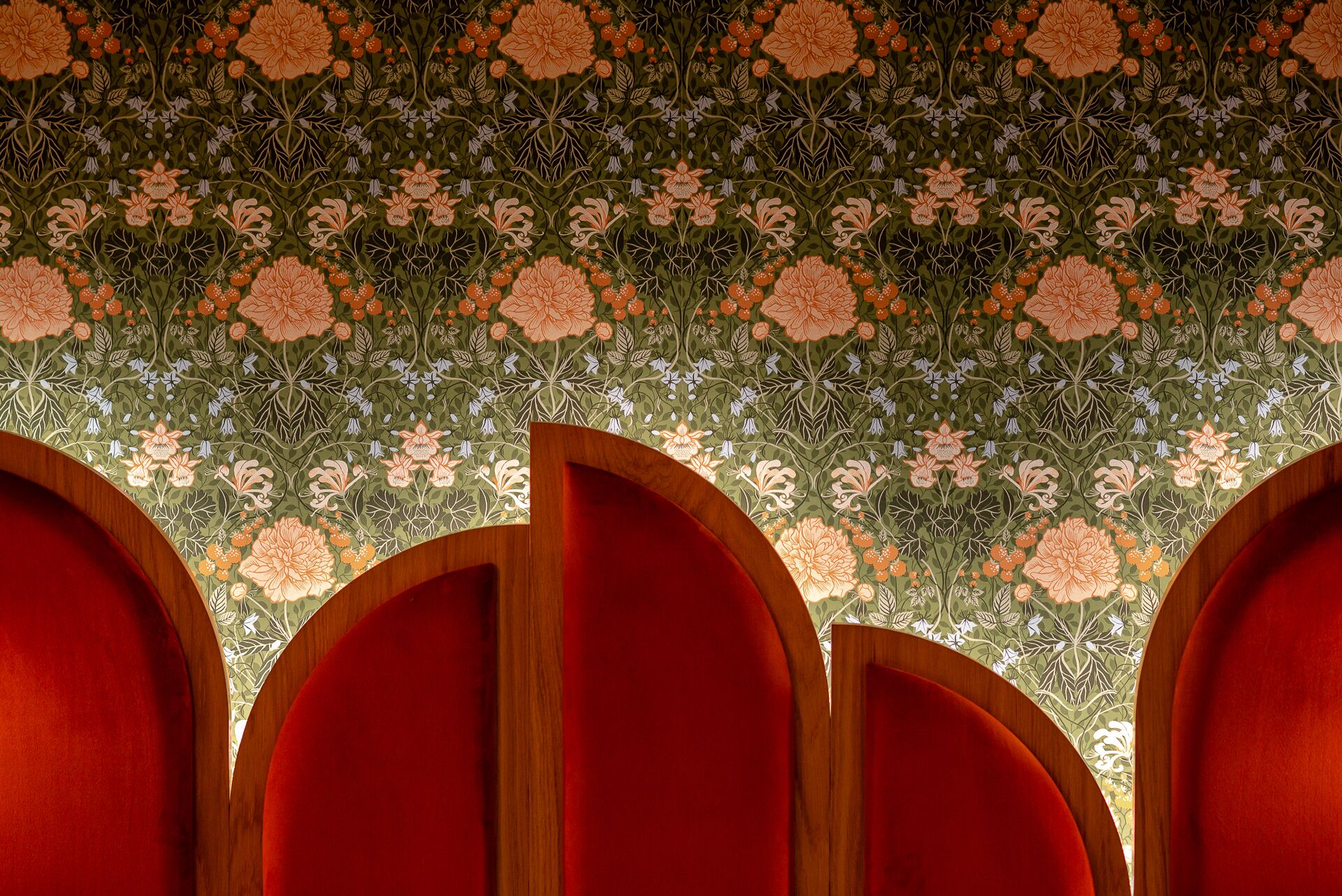 A room with a patterned wallpaper and wooden panel dividers.