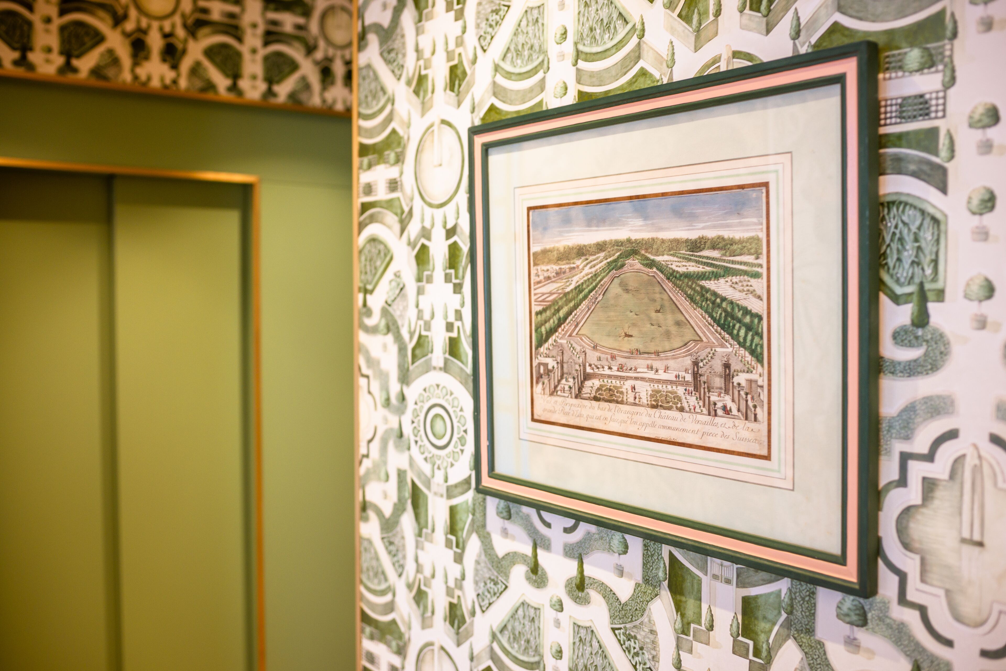 A framed architectural drawing on a wall with intricate patterns.