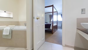 A modern bathroom with a bathtub, a sink, and a shower area. - Roman Way Hotel A5 Cannock (Cannock)