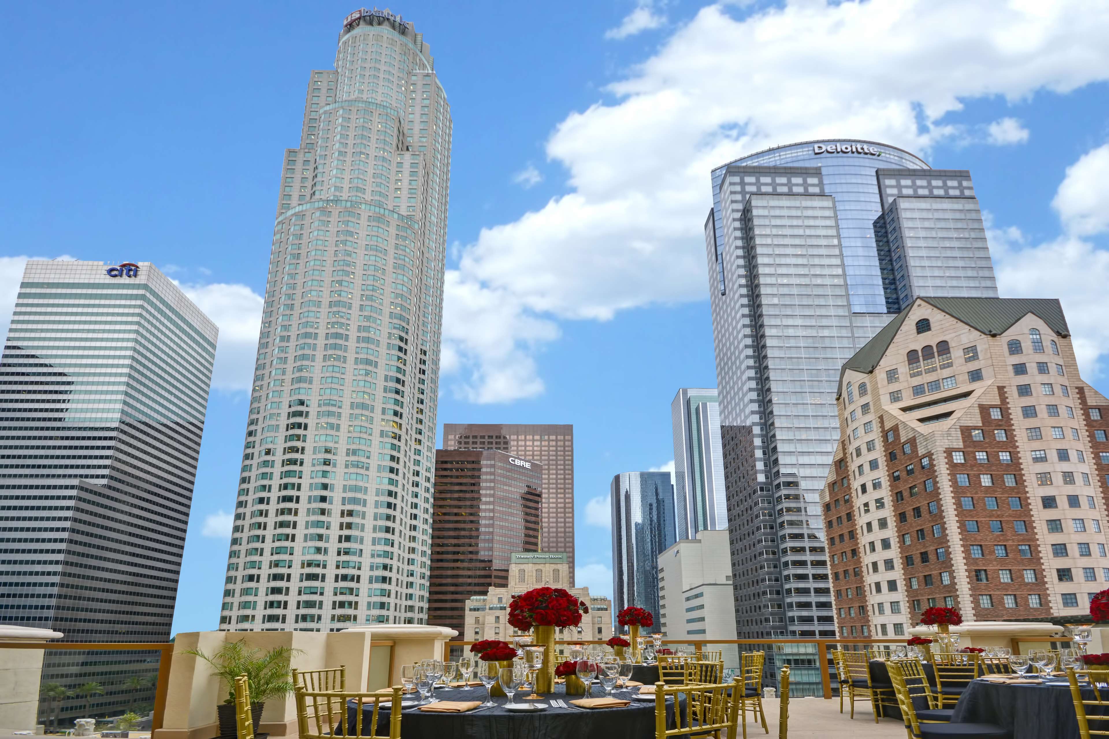 A cityscape with modern skyscrapers, including a building with 'Deloitte' on top.