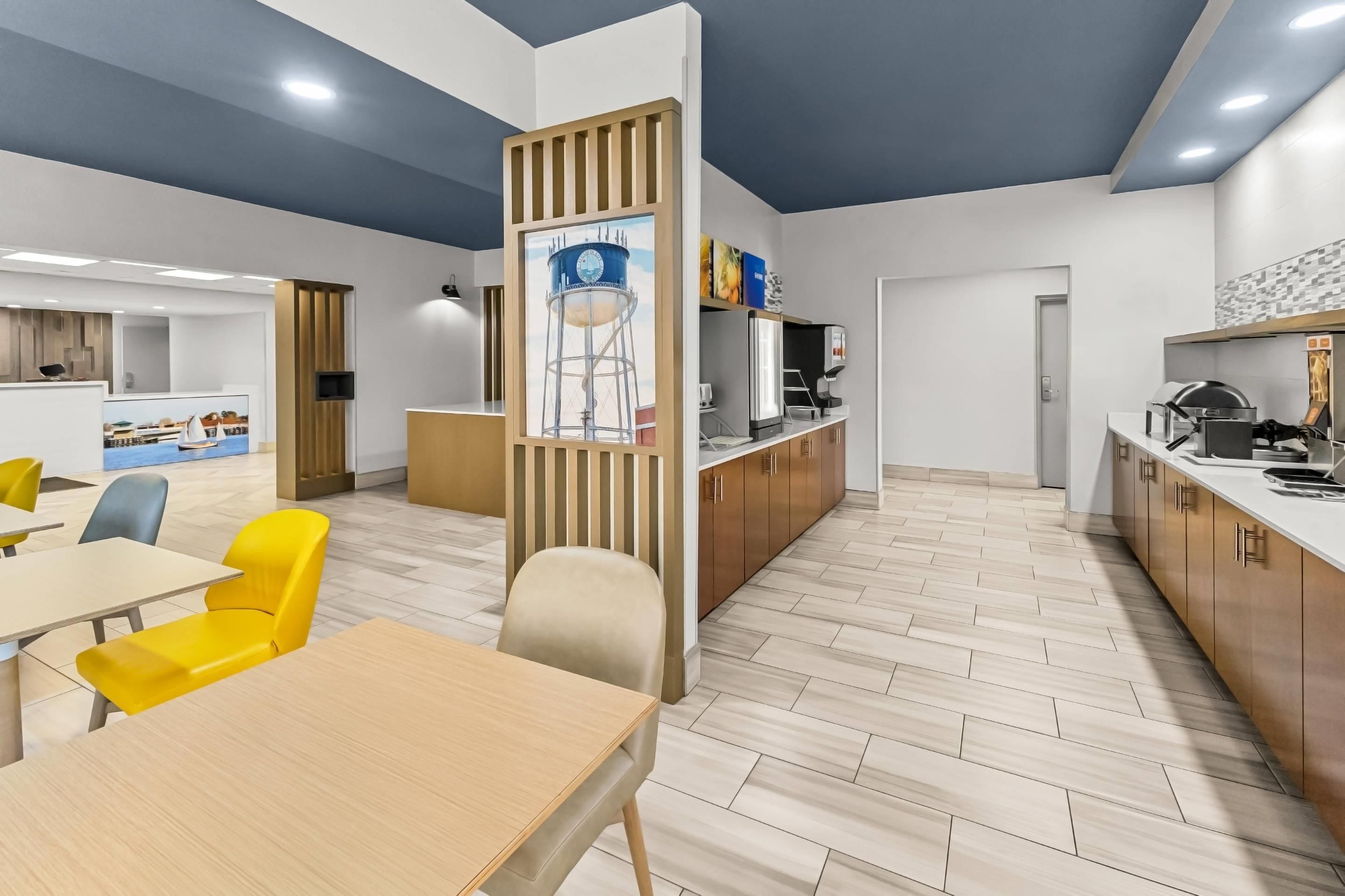 A modern interior with a dining area, kitchen, and a view of the outside.