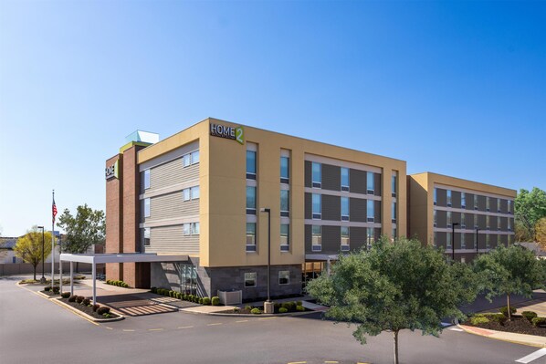 A modern building with a sign reading "HOME 2" and a covered entrance. - Home2 Suites by Hilton Dover, DE (Dover)