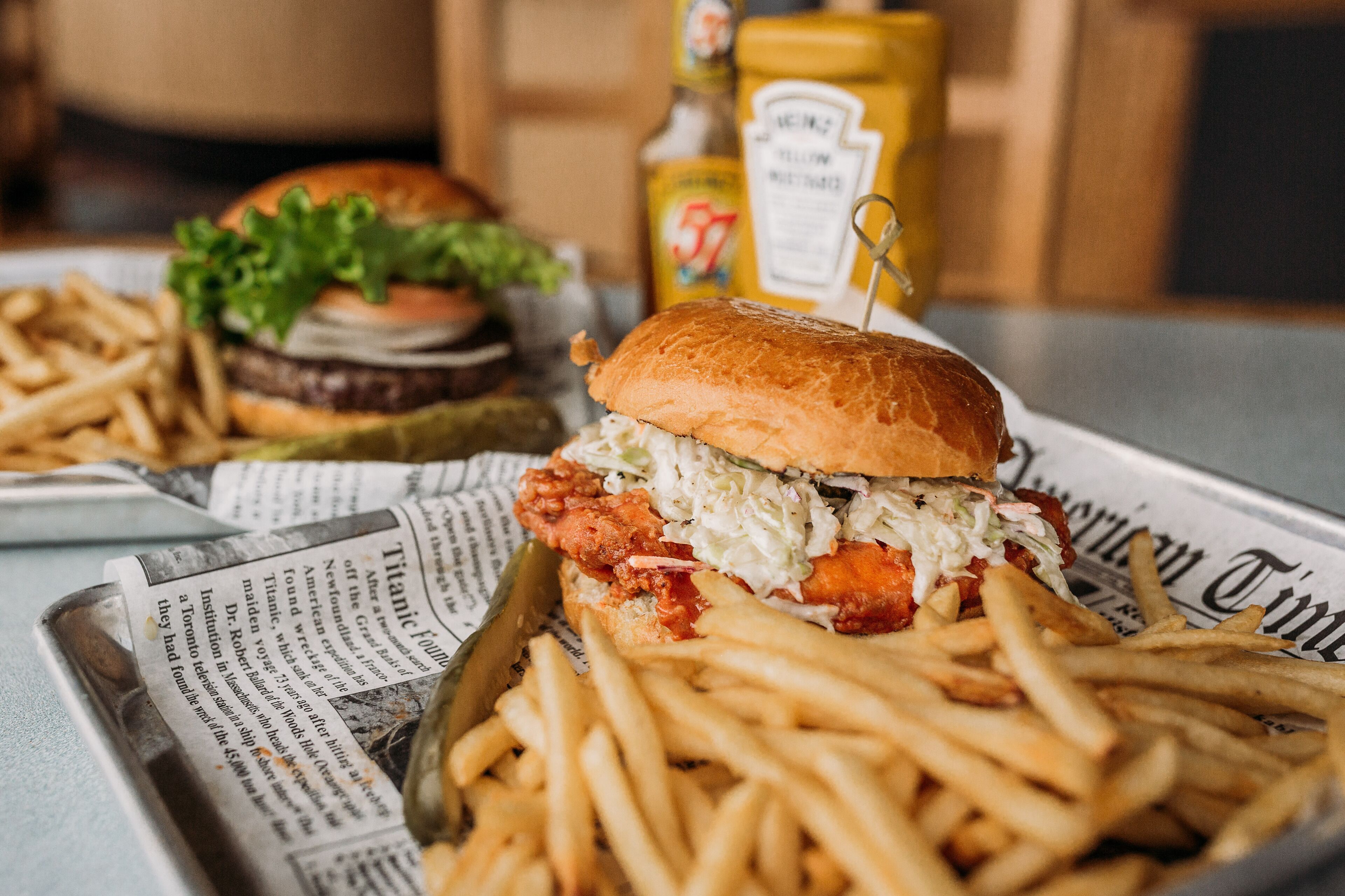 A meal consisting of a sandwich, fries, and a drink on a tray.