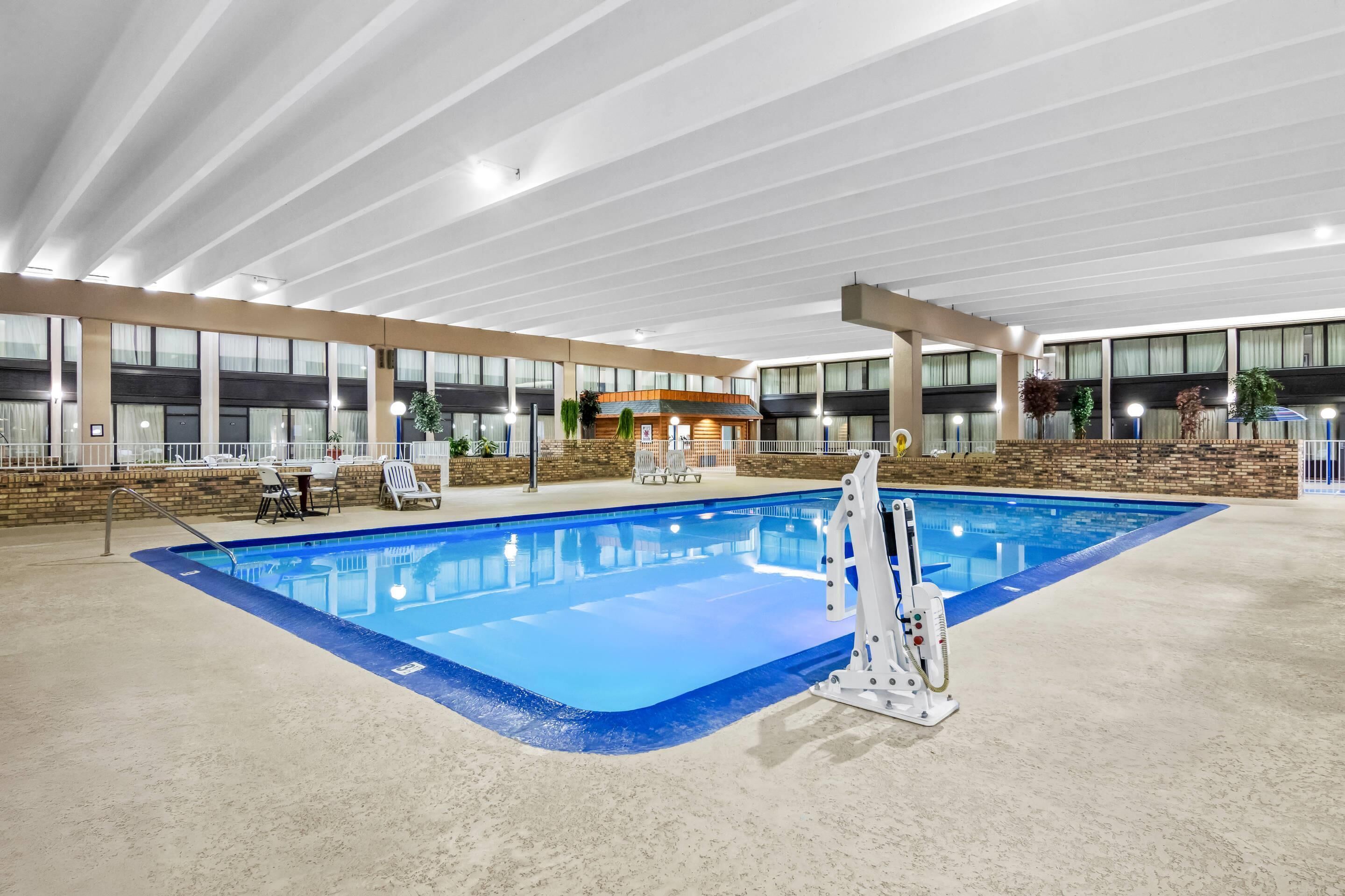 Indoor pool, open 9:00 AM to 10:00 PM, pool umbrellas, pool loungers