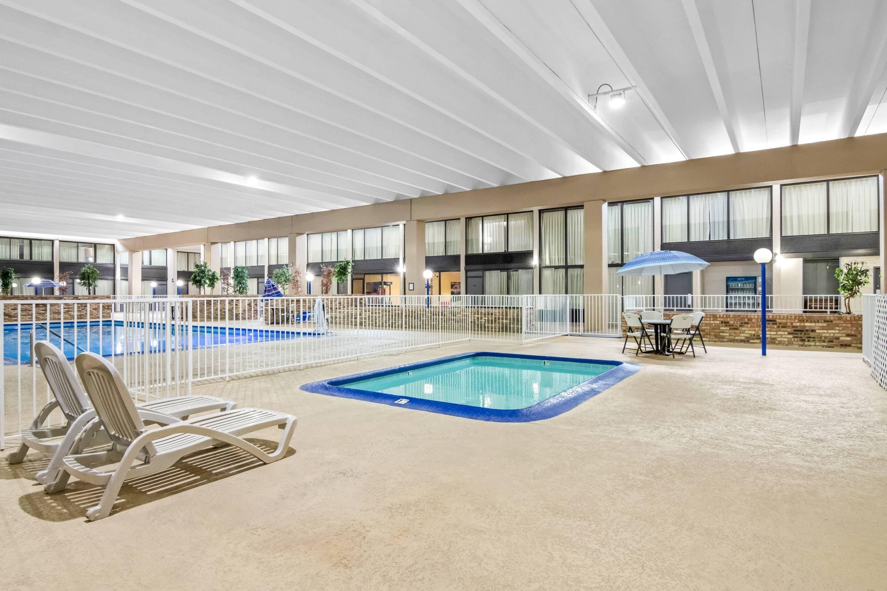 Indoor pool, open 9:00 AM to 10:00 PM, pool umbrellas, pool loungers