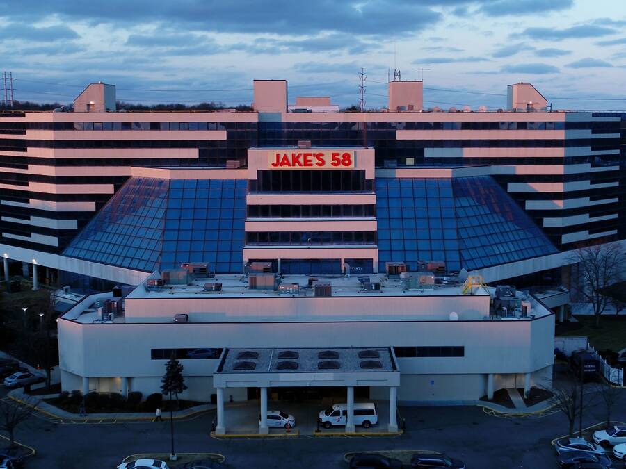 Un edificio moderno con un cartello ben visibile che riporta "JAKE'S 58".