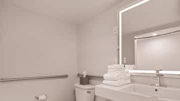 A modern bathroom with a toilet, sink, and mirror.