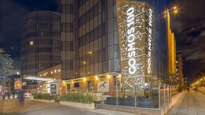 Een modern hotel met een opvallend bord waarop de naam 'ONSOM' staat.