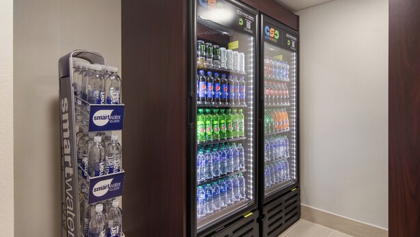 A vending machine with various bottled water and soda options. - Red Roof Inn PLUS+ & Suites Erie (Erie)