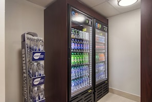 A vending machine with various bottled water and soda options.