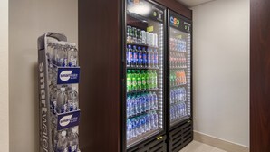 Two beverage dispensers with multiple water and soda options, including smart water and various brands like Pepsi and Coca-Cola. - Red Roof Inn PLUS+ & Suites Erie (Erie)