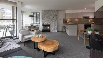 Suite, 2 Bedrooms | Living room | 49-inch LED TV with cable channels, TV, table football