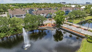 A residential area with houses, a central circular park, and a fountain.