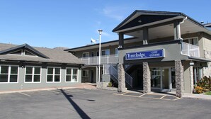 A Travelodge City Centre building with a two-story structure, a balcony, and a staircase leading to the entrance. - Travelodge by Wyndham Kamloops (Kamloops)