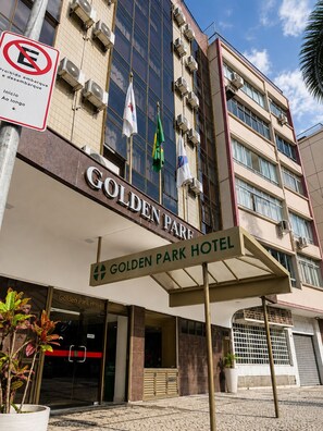 The exterior of the Golden Park Hotel with a clear entrance, a sign prohibiting parking, and multiple flags. - Hotel Golden Park Rio de Janeiro Aeroporto By Nacional Inn (Rio de Janeiro)
