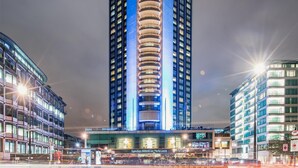 A high-rise building with a central cylindrical structure, multiple floors, and a modern architectural design. - London Hilton on Park Lane (London)