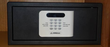 A keypad lock with instructions for use, placed in a black frame.