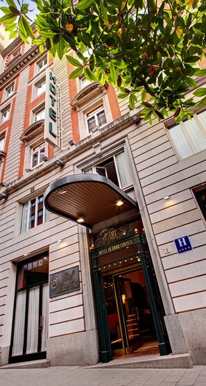 The entrance of Hotel Hernan Cortes with a classic facade, a prominent entrance canopy, and a visible sign indicating it is a hotel. - Hotel Hernán Cortés (Gijon)