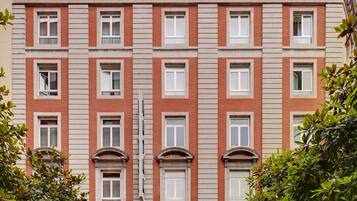 A multi-story hotel with a symmetrical facade, large windows, and a central entrance.