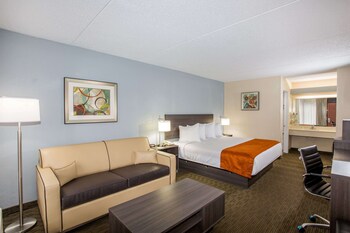 Desk, blackout drapes, iron/ironing board, free cribs/infant beds at Days Inn & Suites by Wyndham Orlando Airport