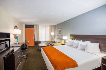 Desk, blackout drapes, iron/ironing board, free cribs/infant beds at Days Inn & Suites by Wyndham Orlando Airport