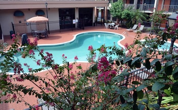 Outdoor pool, open 8:00 AM to 10:00 AM, sun loungers at Days Inn & Suites by Wyndham Orlando Airport