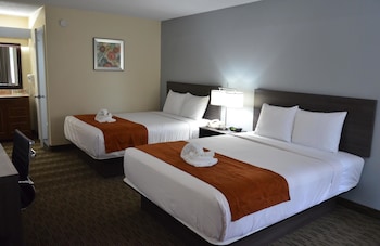 Desk, blackout drapes, iron/ironing board, free cribs/infant beds at Days Inn & Suites by Wyndham Orlando Airport