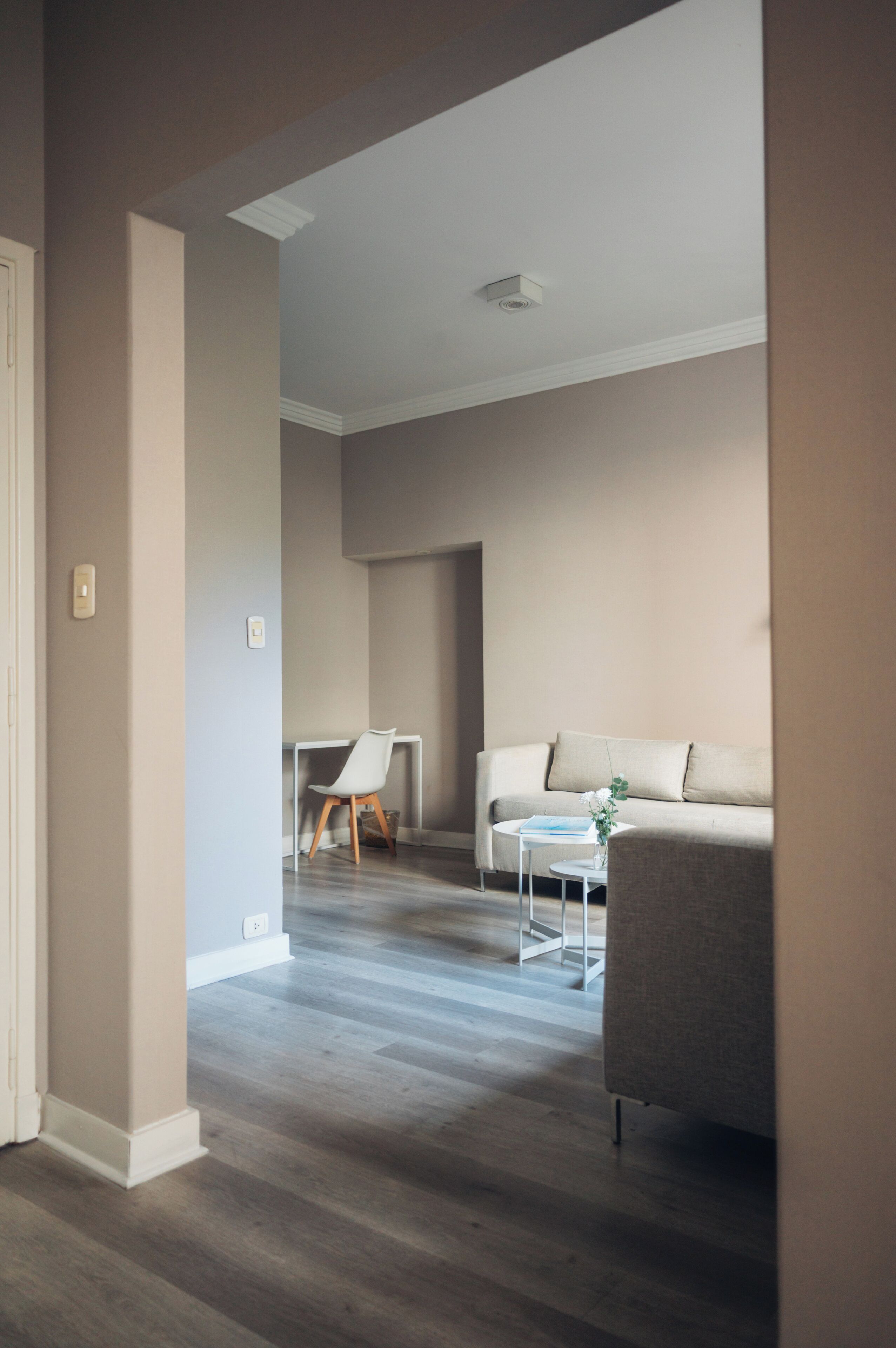 A modern living room with a sofa, a small table, and a chair.