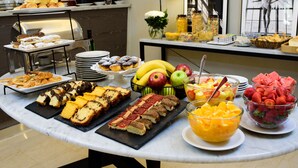 A buffet table with various food items including pastries, fruits, and desserts. - SuMa Recoleta Hotel (Buenos Aires)
