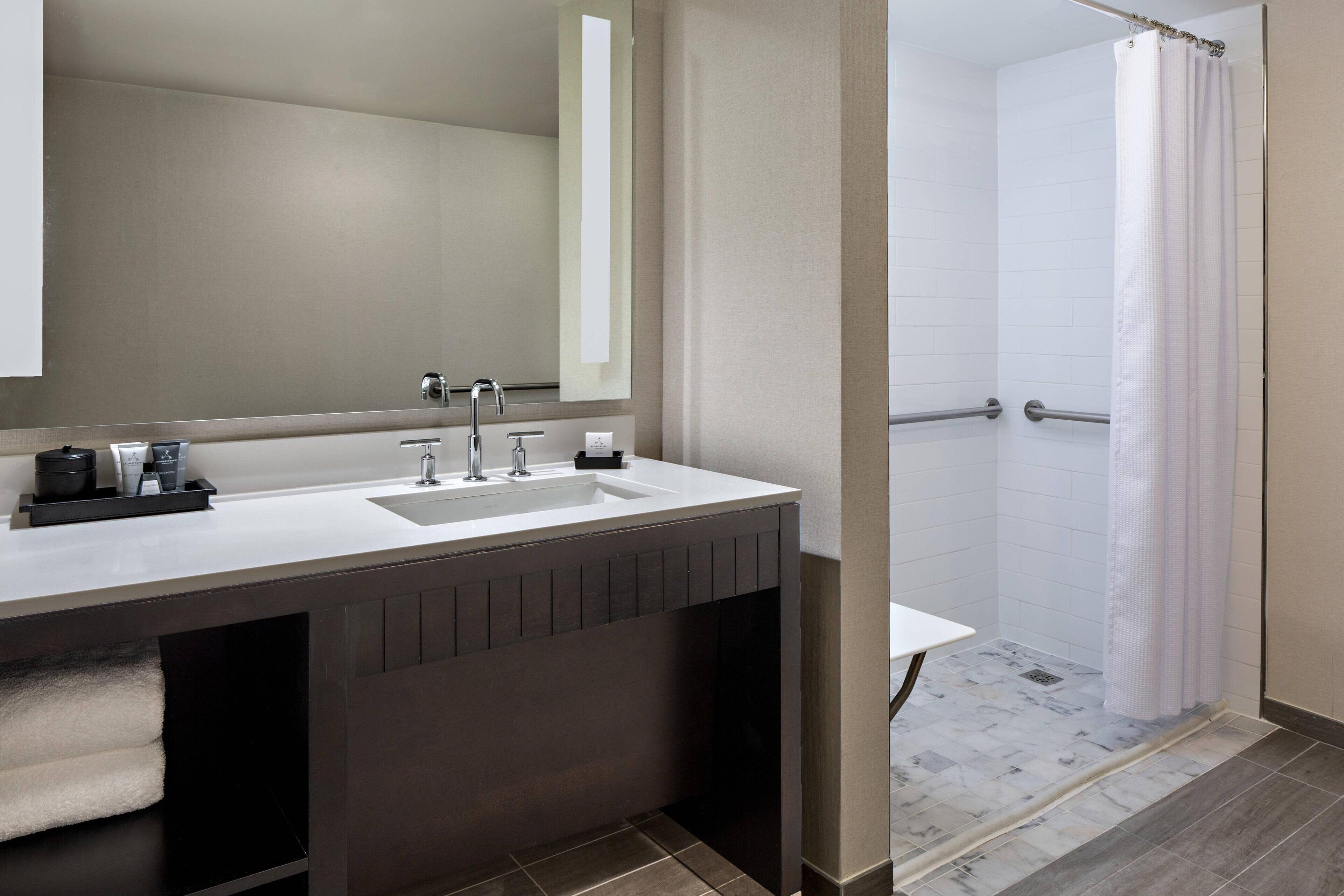 combined shower/bathtub, designer toiletries, hair dryer, bathrobes