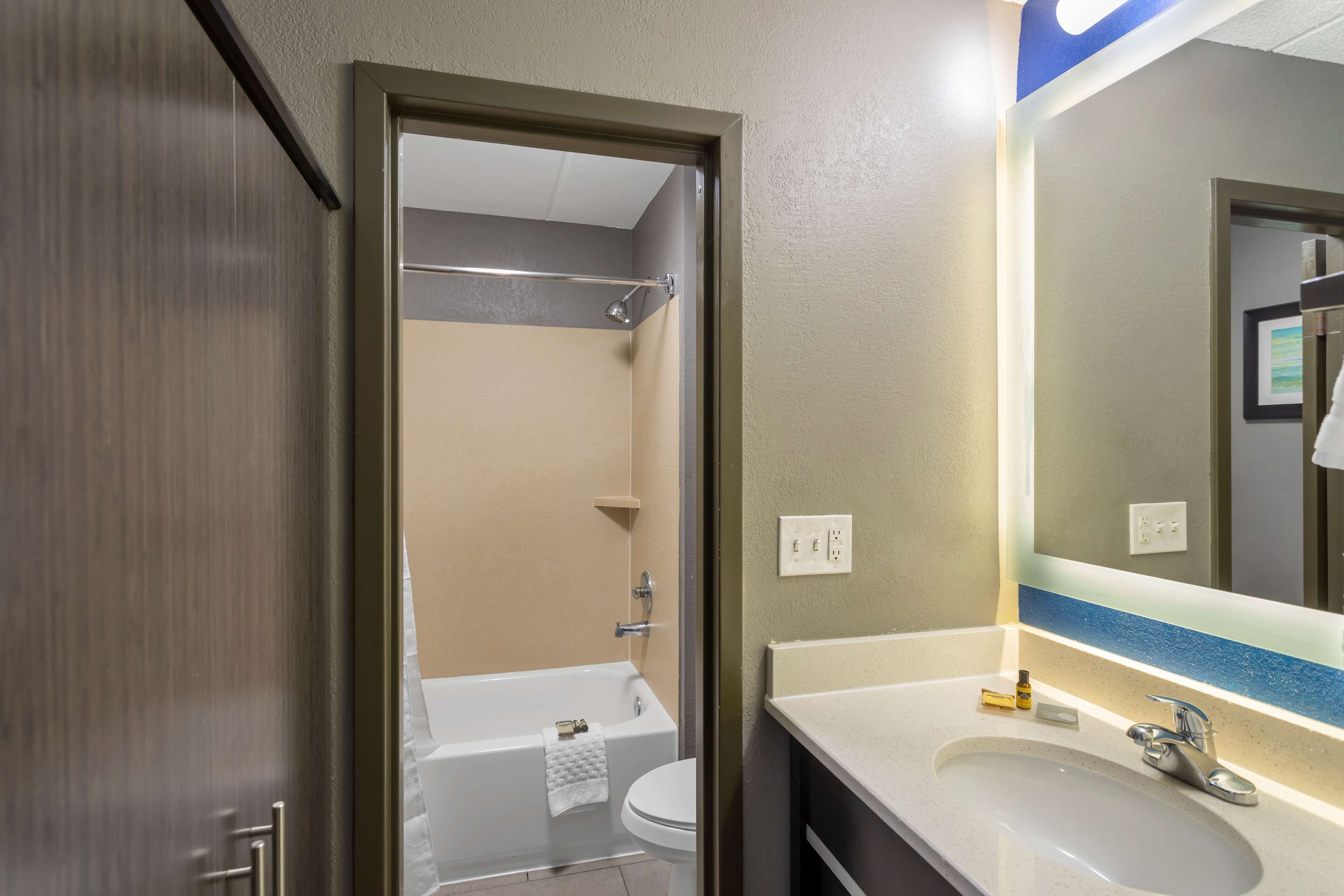 A bathroom with a bathtub, toilet, and sink.