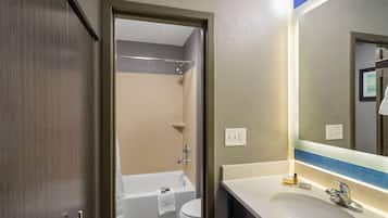 A bathroom with a bathtub, toilet, and sink.