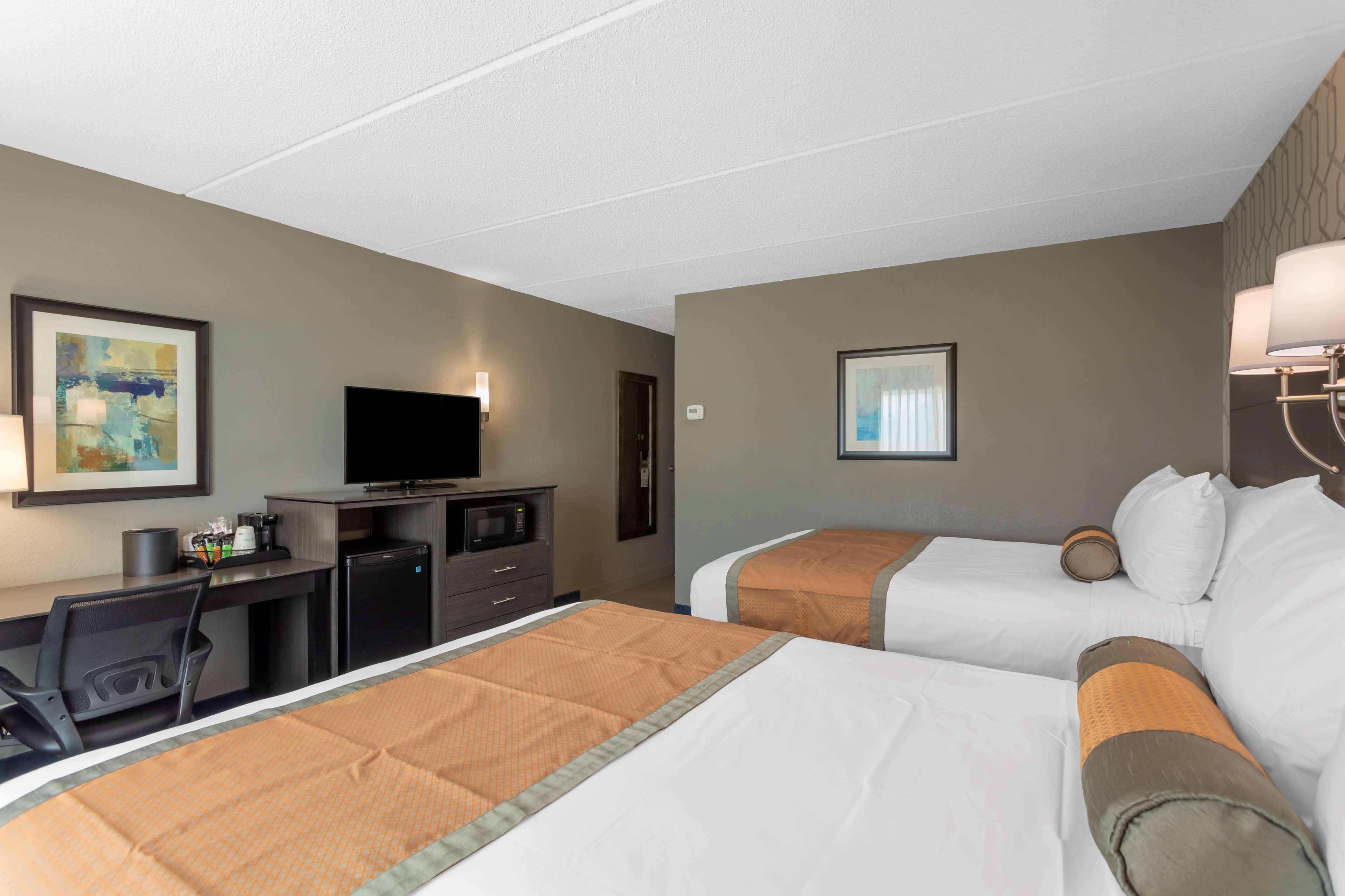 desk, laptop workspace, iron/ironing board, bed sheets