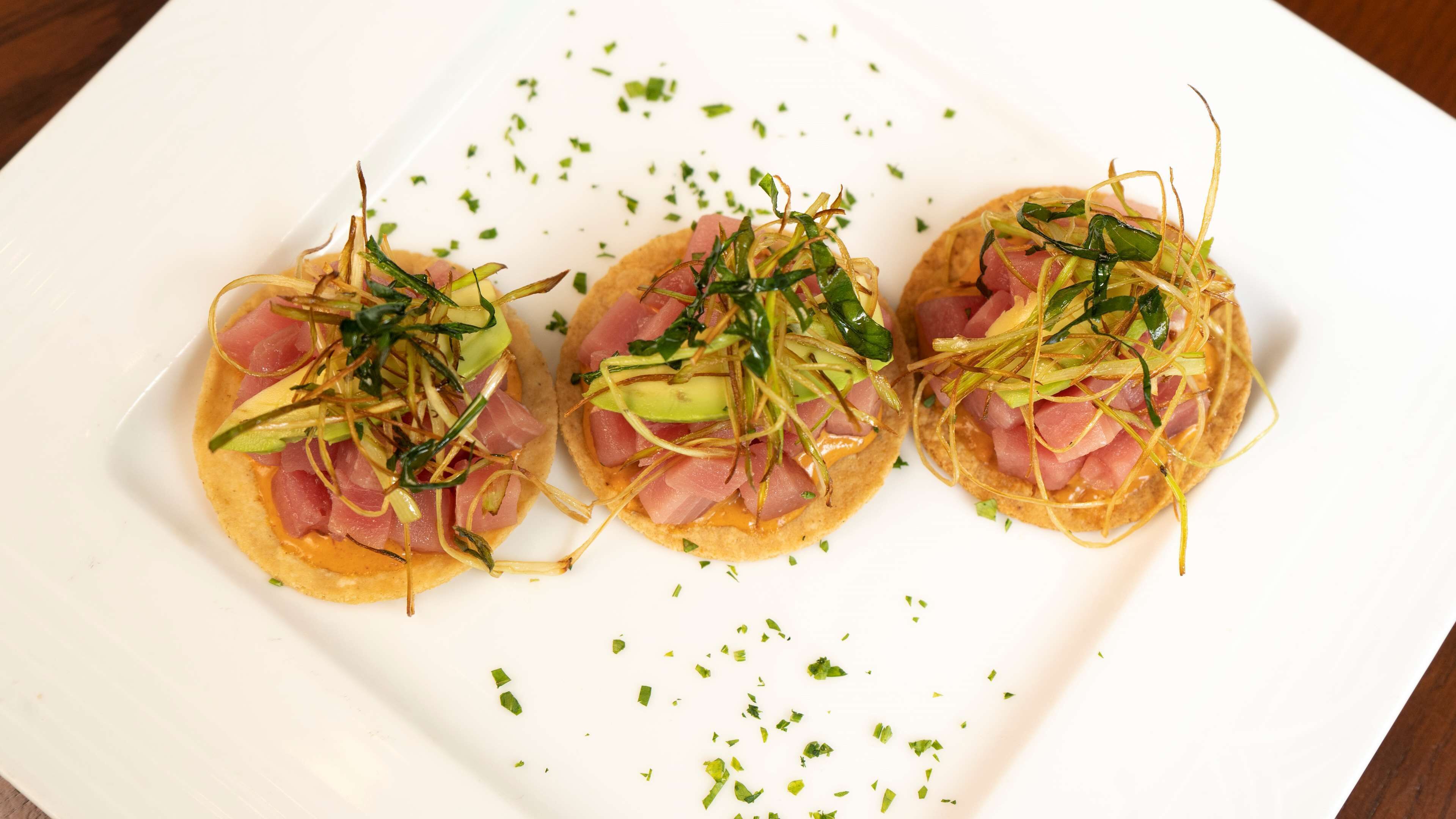 Three appetizers on a white plate.