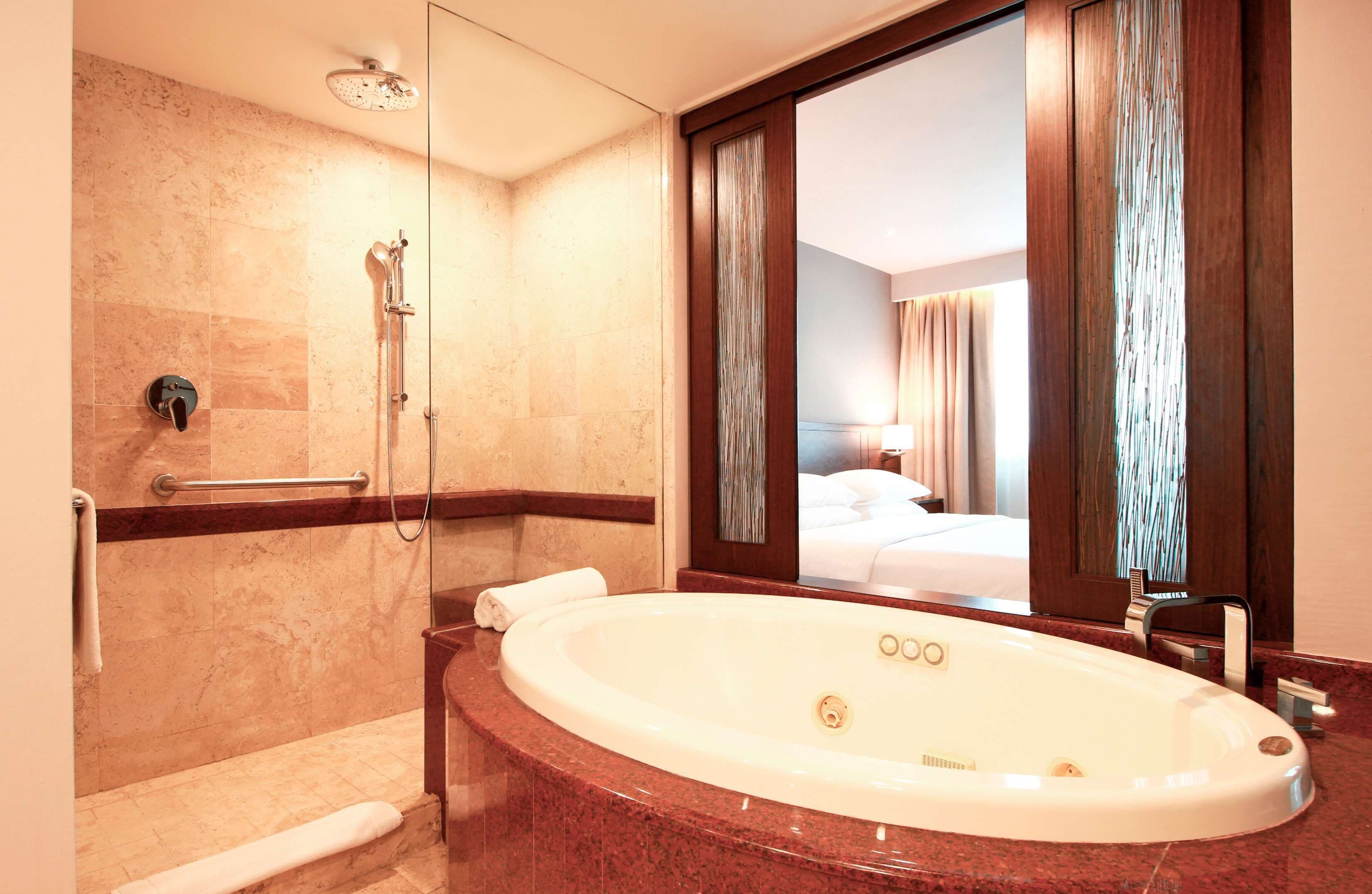 suite, 1 king bed with sofa bed | bathroom | shower, rainfall showerhead, hair dryer, bathrobes