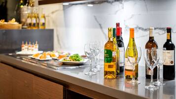 A bar area with various bottles of wine and glasses.