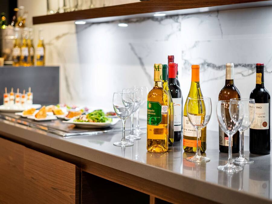 A bar area with various bottles of wine and glasses.