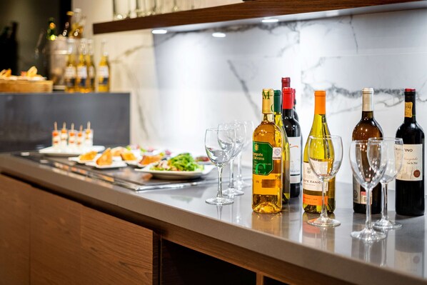Zona de bar con diferentes botellas de vino y copas.