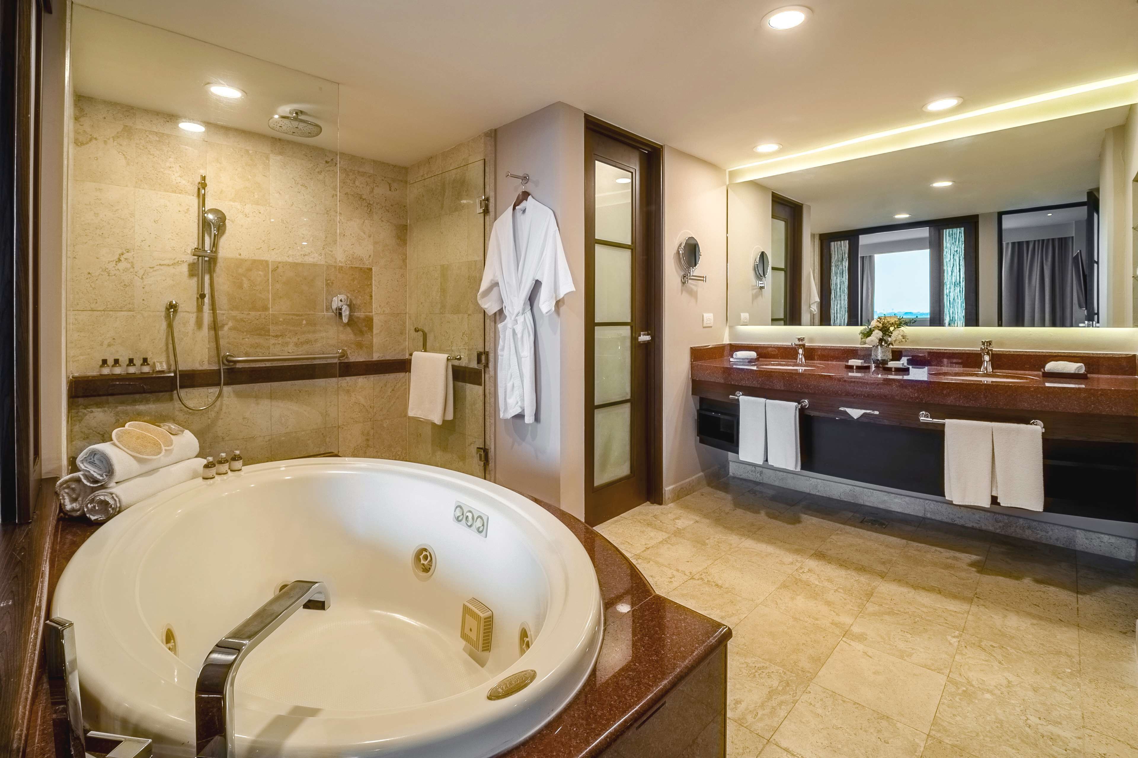 suite, 1 king bed with sofa bed | bathroom | shower, rainfall showerhead, hair dryer, bathrobes
