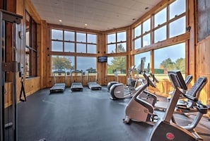 A gym with treadmills, elliptical machines, and a large windowed wall. - Grandview Lake Placid (Lake Placid)