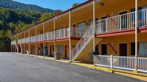 A motel with a two-story structure, multiple balconies, and a parking lot. - Econo Lodge Near Bluefield College (Bluefield)