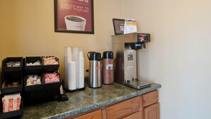 A hotel reception area with a coffee machine, paper cups, and a framed sign advertising 'Easy Starts' continental breakfast. - Econo Lodge Near Bluefield College (Bluefield)