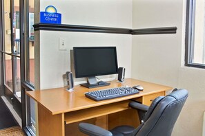 A business center desk with a computer, keyboard, mouse, and speakers. - Days Inn by Wyndham Lawrenceville (Lawrenceville)