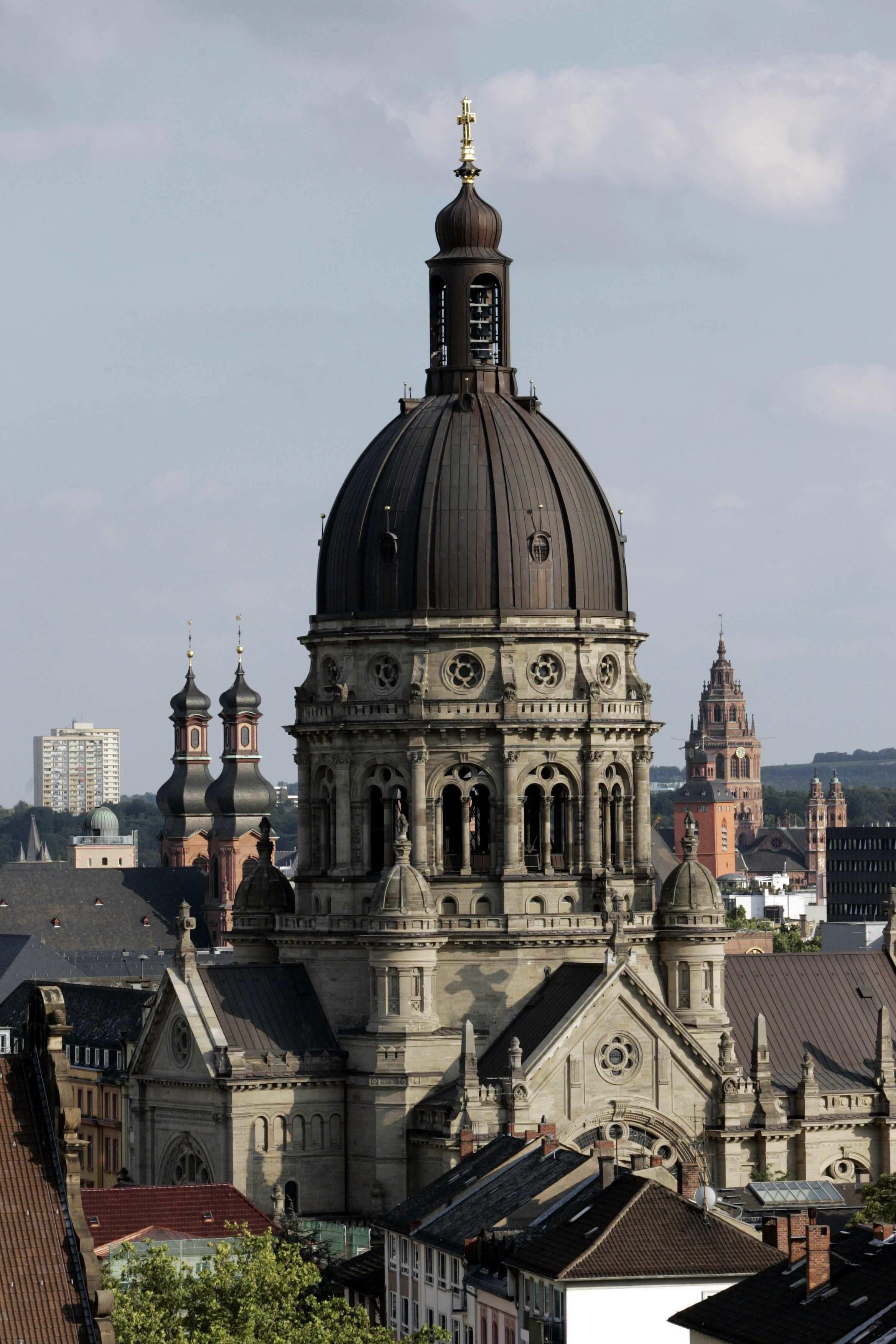 Eine historische Kirche mit einer großen Kuppel und mehreren Türmen, umgeben von anderen Gebäuden.